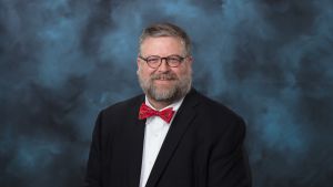 white male, glasses, beard, short brown and gray hair